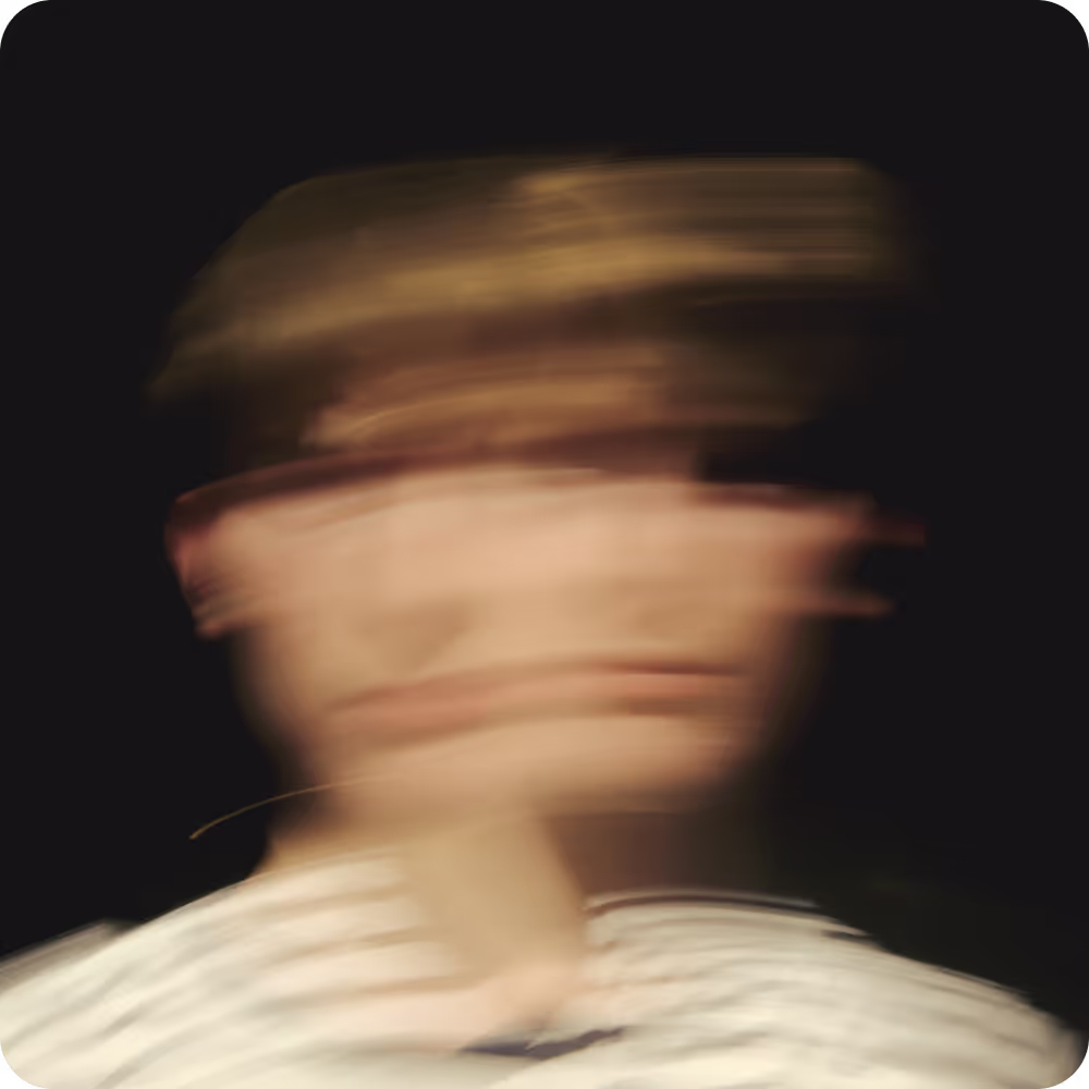 Image of a blurred image of a man wearing a white shirt, creating an abstract and indistinct visual effect.