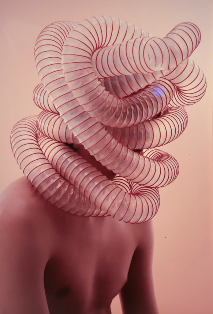 Image of a man with a large head adorned with multiple tubes, showcasing a unique and intriguing visual concept.